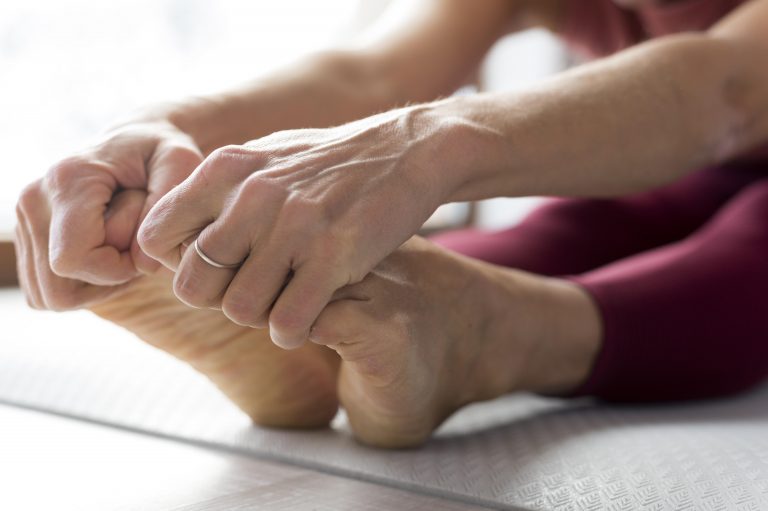 close-up-legs-hands-doing-stretching-exercises