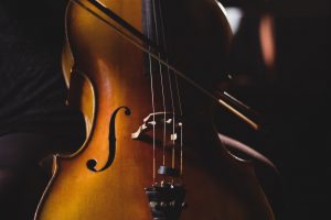 Female student playing violin in a studio