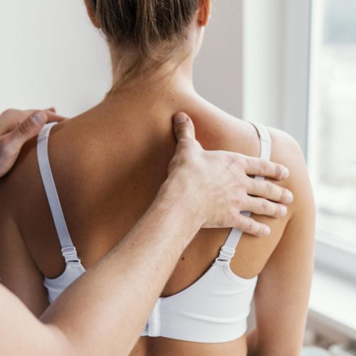 male-osteopathic-therapist-checking-female-patient-s-upper-spine