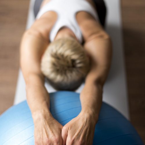 senior-woman-with-short-hair-doing-stretching-exercises
