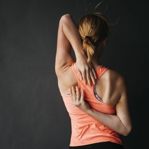 sporty-woman-stretching-urban-environment