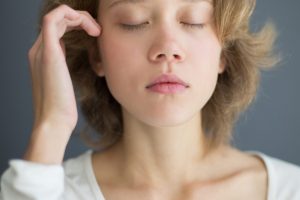 Vertical portrait of sensual beautiful woman thoughtfully closing her eyes